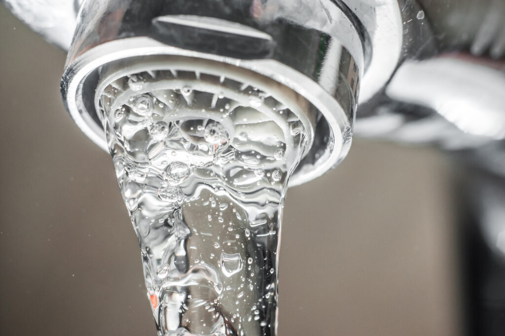 stock-photo-frozen-water-stream-from-a-tap-close-up-aerator-operation-for-saving-water-consumption-1551943532