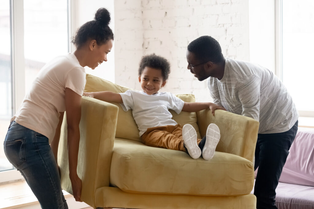 stock-photo-african-couple-carrying-armchair-where-sit-adorable-small-toddler-son-happy-family-placing-1746174692