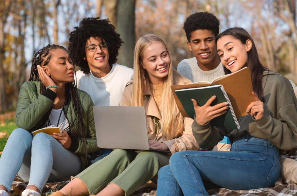 stock-photo-multiracial-students-making-group-project-studying-together-at-public-park-1810290874