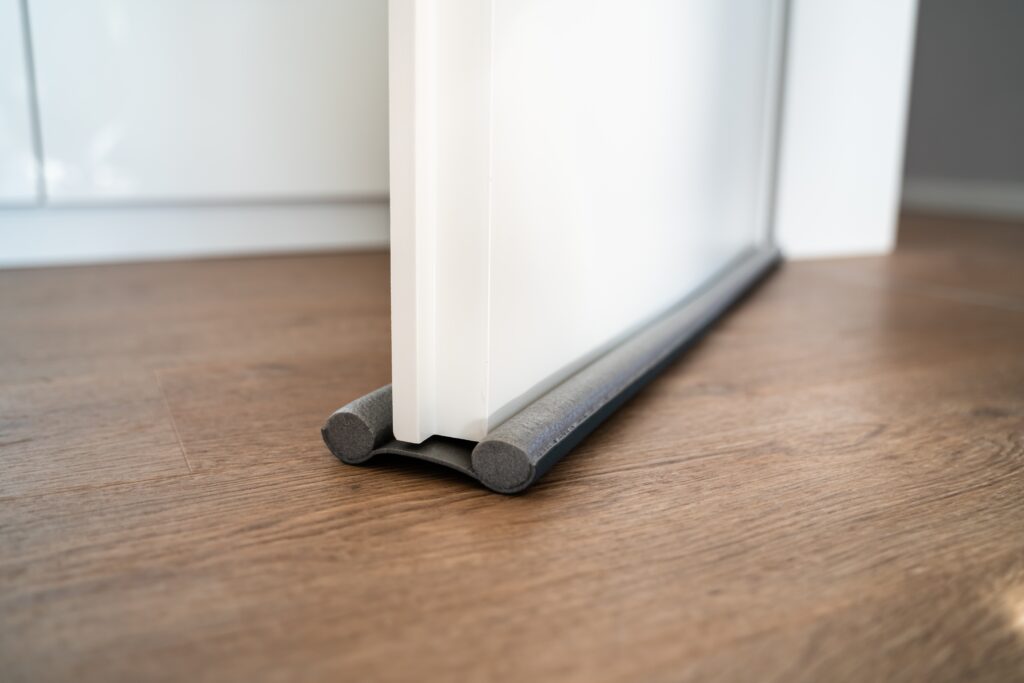 stock-photo-door-draft-stopper-or-excluder-stop-cold-air-2070184271