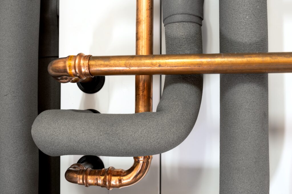stock-photo-insulation-on-a-heating-pipeline-2437705379