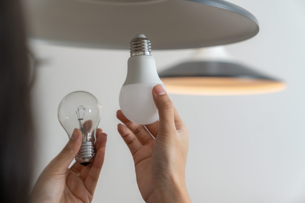 stock-photo-the-young-woman-is-changing-light-bulbs-at-home-2472024545