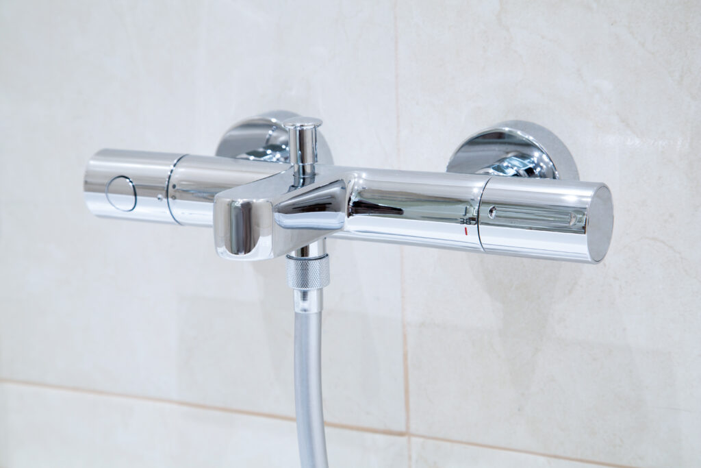 stock-photo-a-new-modern-thermostatic-shower-faucet-on-the-wall-in-bathroom-347028434