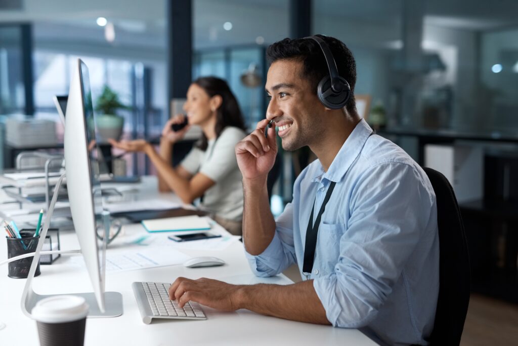 stock-photo-dedicated-service-creates-dedicated-customers-shot-of-a-young-man-using-a-headset-and-computer-in-2149264361