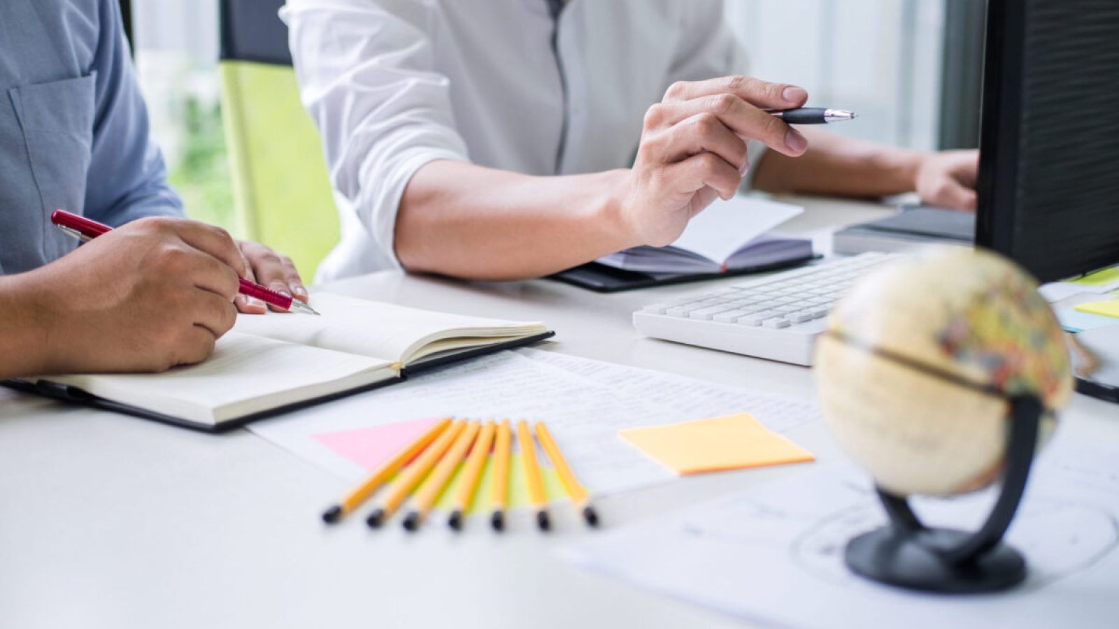 stock-photo-tutor-books-with-friends-man-sitting-pointing-studying-together-at-desk-with-classmates-exams-1391413694