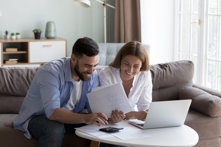stock-photo-cheerful-young-millennial-husband-and-wife-doing-domestic-paperwork-accounting-job-reviewing-2203225387