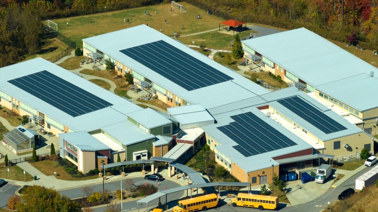 stock-photo-aerial-view-of-american-school-building-with-rooftop-covered-with-photovoltaic-solar-panels-for-2249747763