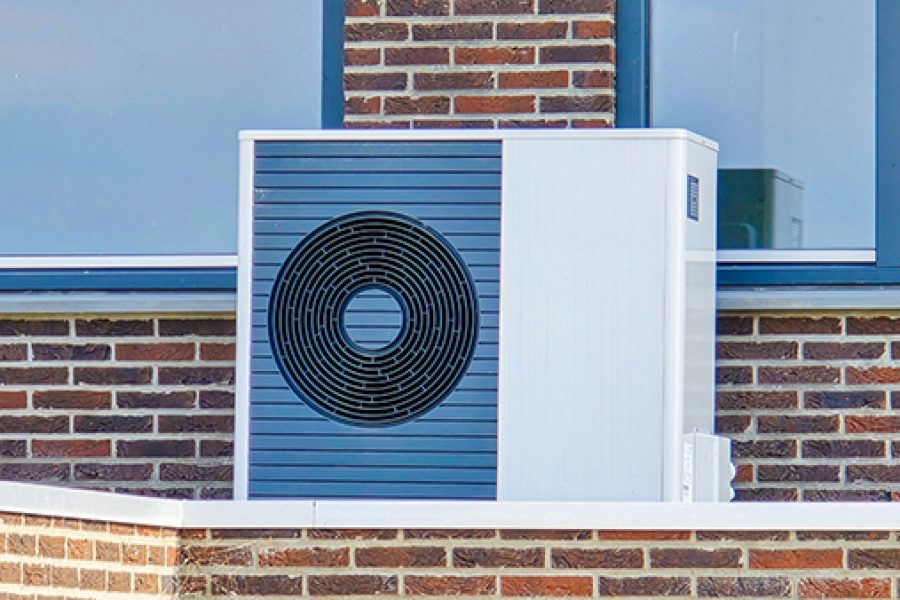 air source heat pump unit installed outdoors at a modern home in the Netherlands in spring, warmte pomp translation air source heat pump, energy transition from natural gas to electric source