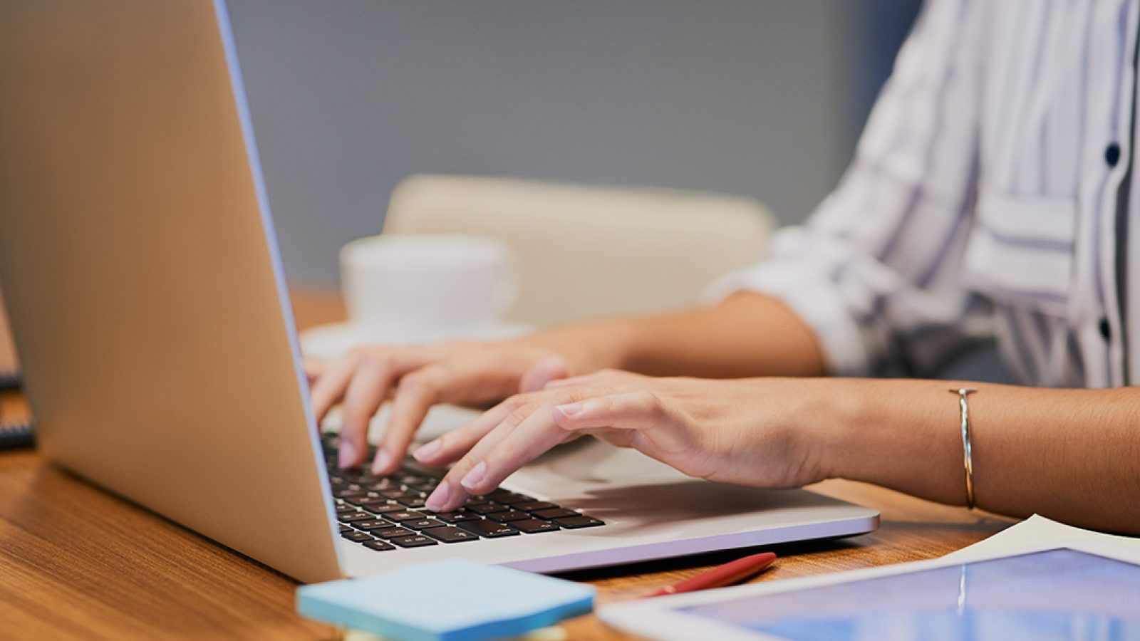 Hands, business person and typing on computer for research, editing email or networking. Laptop, worker and writing on keyboard closeup for publication results or check manuscript in creative startup