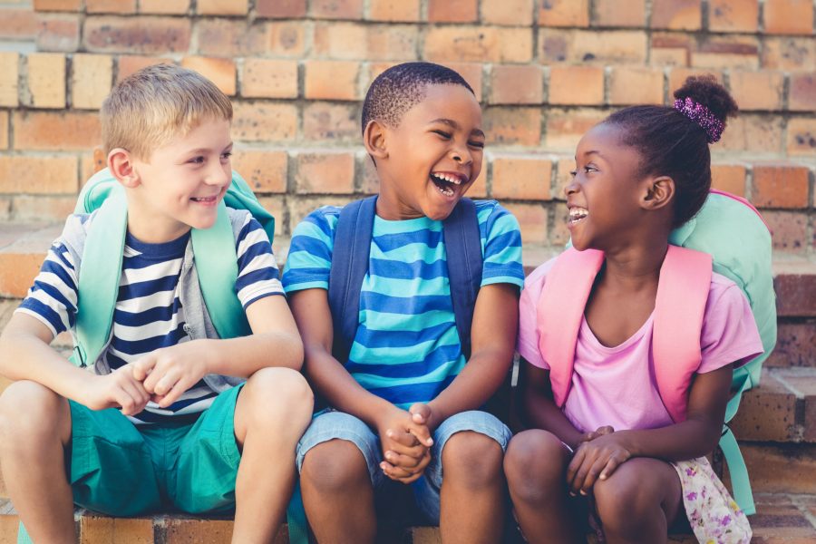 stock-photo-happy-school-kids-sitting-together-on-staircase-at-school-447170968